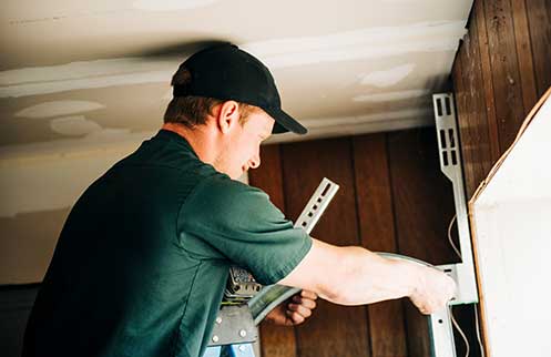 Technician Repairing Garage Door